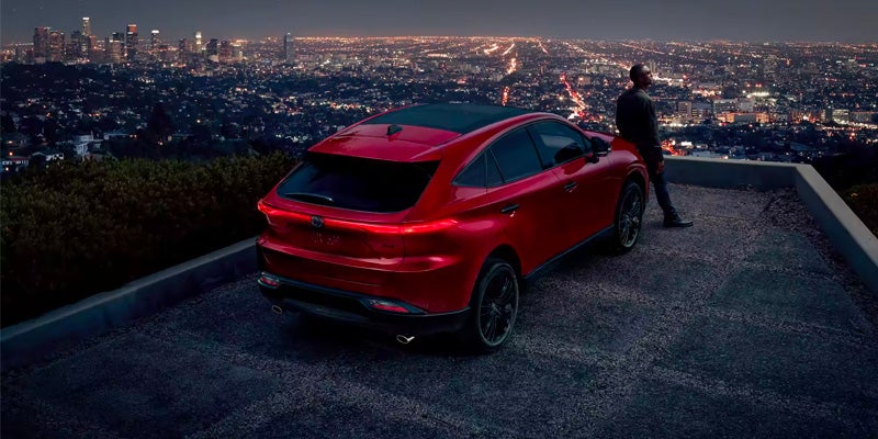 A parked Toyota Venza, overlooking a city at night