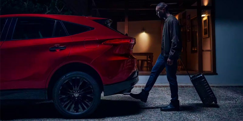 A man opens the trunk of a Toyota Venza