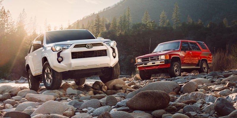 Two 4Runners parked on a rocky beach.