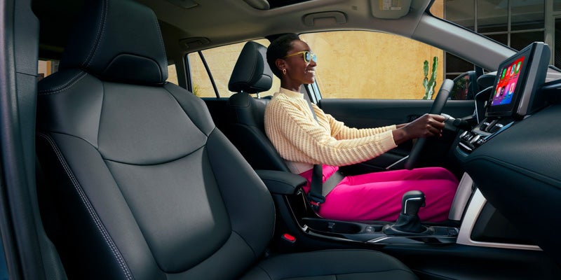 Interior view of a woman driving a Toyota Corolla Cross