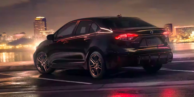 Rearview of a Toyota Corolla parked at night.