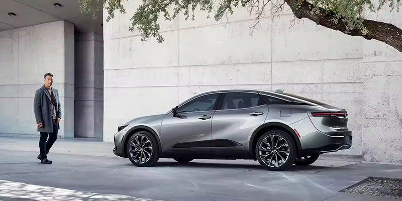 A Toyota Crown parked outside a concrete building