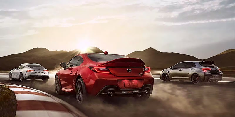 Three Toyotas race around a track