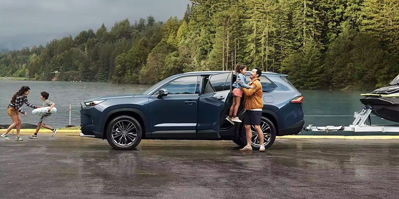A family exits a 2024 Toyota Grand Highlander