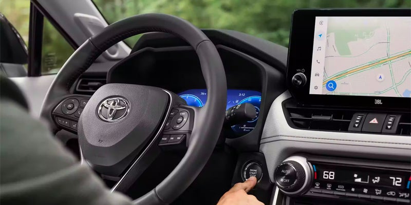 Man starting the engine of a 2024 Toyota Rav4