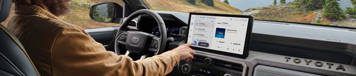 Man using touch screen in a 2024 Toyota Tacoma in Johnstown, NY