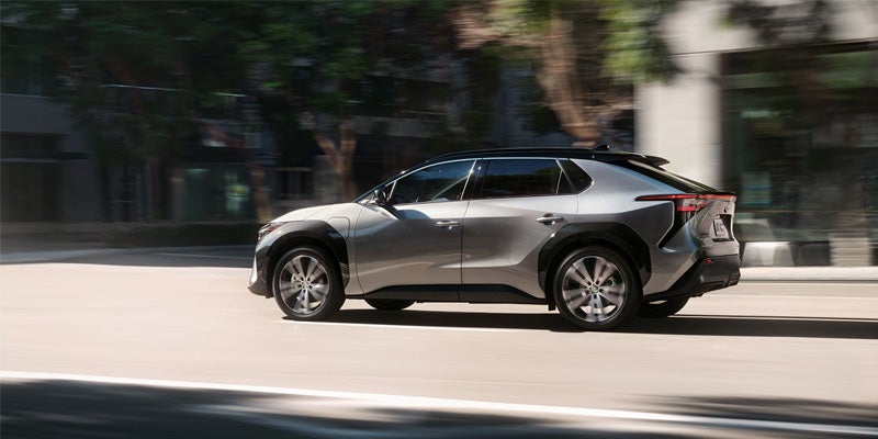 A Toyota bZ4X drives through a city