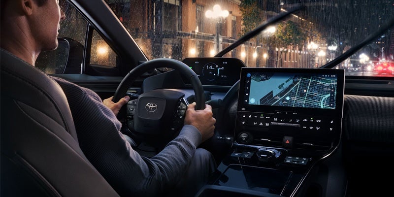 A man driving a Toyota bZ4X