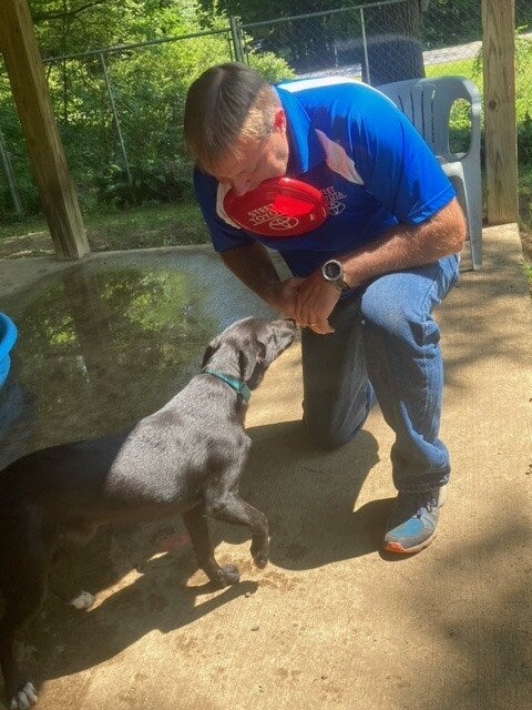 man playing frisbee with dog Steet Toyota of Johnstown in Johnstown NY